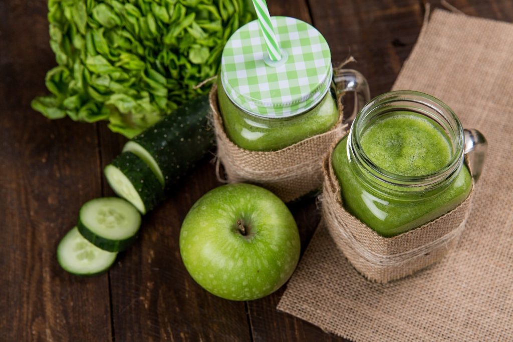 Bottle Gourd Juice is Good for Digestion - Green Apple Beside of Two Clear Glass Jars